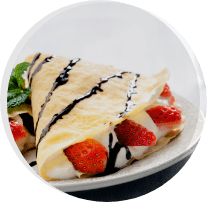 A close up of some crepes with strawberries