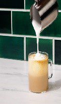 A glass of milk being poured into it.