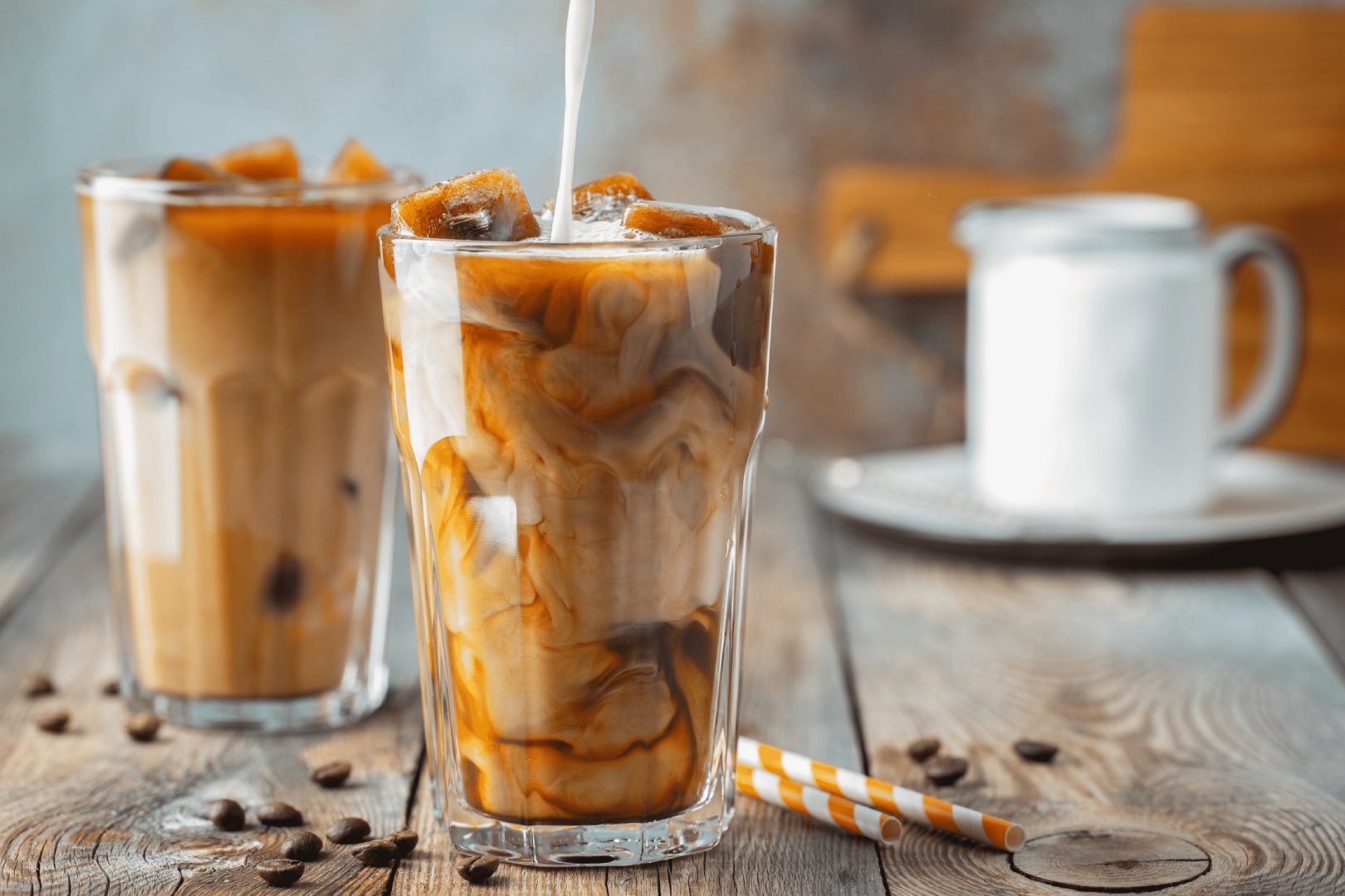 A glass of iced coffee with milk and caramel.